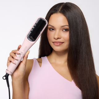 Woman with long straight hair holding pink SteamSmooth heated brush