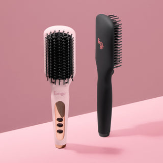Side-by-side view of two L’ange Le Vite straightening brushes in blush pink with rose gold accents and matte black with pink logo detailing, set against a pink background