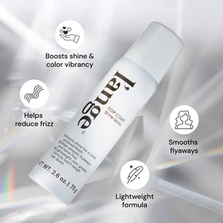L'ange Top Coat Shine Spray bottle on a reflective surface with icon callouts reading "Boosts shine & Color Vibrancy " "Helps reduce frizz" "Smooths flyaways" and "lightweight formula"