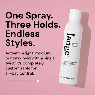 L’ange Trois Chic Three Way Hairspray bottle on a pink background. Text reads: “One Spray. Three Holds. Endless Styles.” “Activate a light, medium, or heavy hold with a single twist. It’s completely customizable for all-day control.” 
