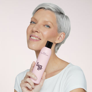 Blonde model holding violet shampoo 