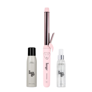 Pink curling wand with a silver barrel, accompanied by a bottle of dry shampoo and a hair and body spray.
