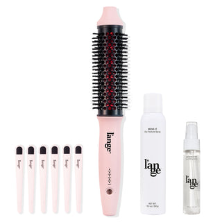 Pink styling tool set featuring a heated hairbrush, a set of five sectioning clips, a bottle of dry texture spray, and nourishing gloss spray.
