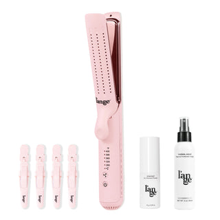 Pink hair styling set featuring a digital flat iron with adjustable temperature settings, four matching hair clips, a bottle of dry shampoo powder, and thermal protectant spray.