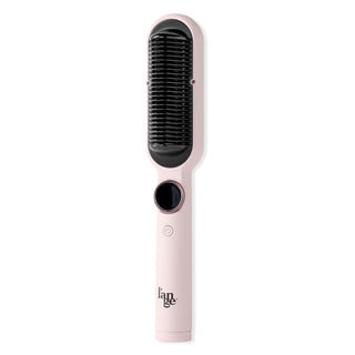 A pink handheld heated styling brush with a black bristle pad, featuring a circular control button and a power button on the handle.