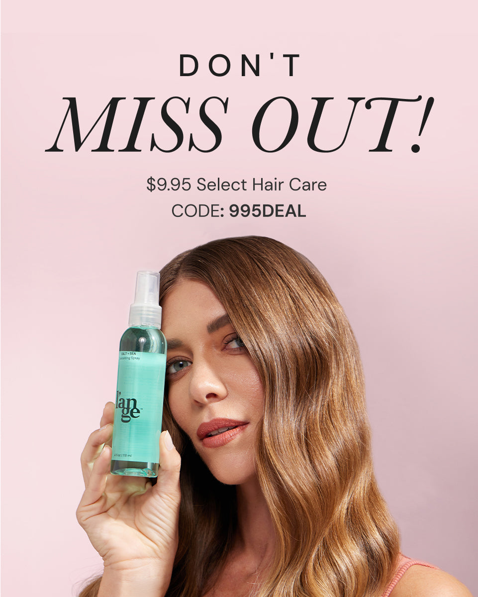 Promotional banner with the text 'DON'T MISS OUT!' in bold black lettering on a light pink background, advertising $9.95 select hair care with promo code 995DEAL. A woman with long, shiny, wavy brunette hair holds up a green bottle of L'ange Salt + Sea Texturizing Spray, smiling slightly while showcasing the product.