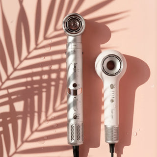 L'ange hair styling tools (TurboStyle and Axia HaloRing) arranged on a peach background with palm leaf shadow