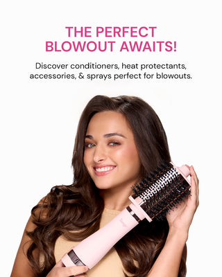 A smiling woman with long, wavy hair holds a pink styling tool, promoting products for achieving an ideal blowout.