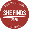 A circular red award badge with white text reading 'beauty awards SHE FINDS 2026 winner' on a plain white background.