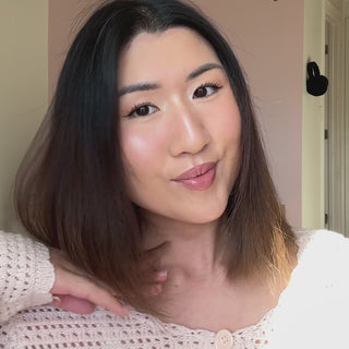 Brunette woman applying Selecte to hair