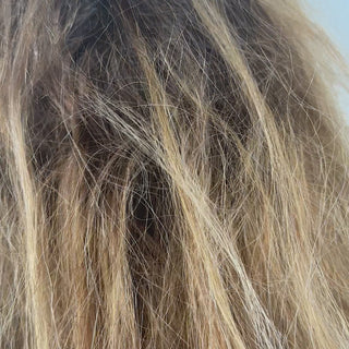 A  blonde woman applies Beyond Multi-Purpose cream to help repair her hair leading to a transformation