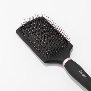 You can clearly see the rounded, pink-tipped bristles on the black nylon bristle brush.