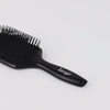 Zoomed in video of Black Beech wood paddle brush with firm & flexible black bristles with white L’ange logo