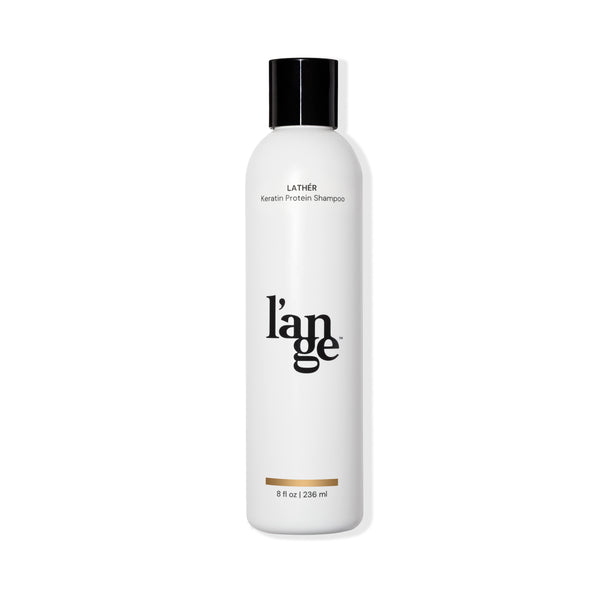White 8oz bottle with black Lather Keratin Protein Shampoo, black L’ange logo & black cap