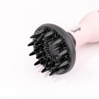 The black Doux diffuser is attached to Soleil hair dryer with the vented side facing you.