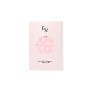 There is a circular window in the pink packaging of the double-sided shower cap so you can see it.