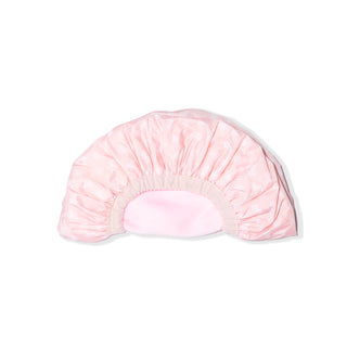 The reversible shower cap is folded in half so you can see the light elastic and both sides.