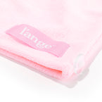 You get a closeup view of the securing ribbon loop on the corner of the hair towel with the logo.