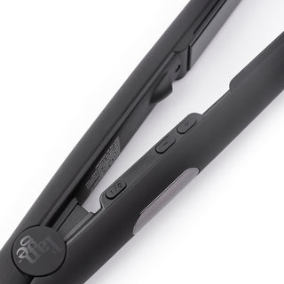 Zoomed in view of black flat iron with temperature button and ON/OFF buttons with black L’ange logo