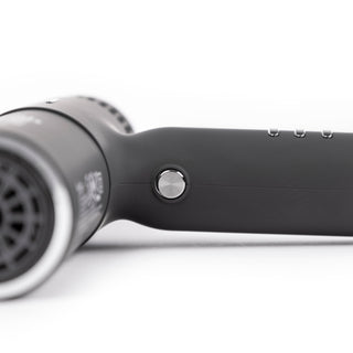 Zoomed in view of black hair dryer withsilver cool shot button