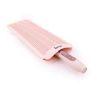 A tool is inserted into the heat-resistant mat with the handle sticking out of the open end.