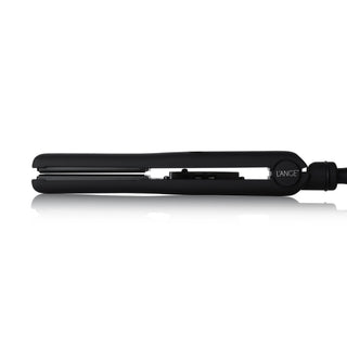A black hair straightener with a sleek design, featuring a reflective surface beneath it and branding on the handle.