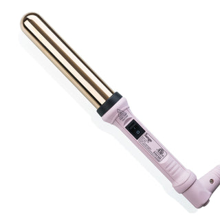 A gold and pink curling wand with a power switch and safety warnings on the handle.